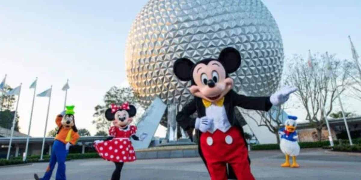 Mickey, Minnie, Goofy, and Donald Duck smile in front of Epcot’s Spaceship Earth at Disney World amid vendor policy changes.