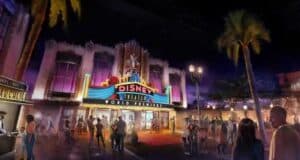 Fans fill the plaza outside Disney Theater at night, neon lights and palm trees glowing, for the debut of a new Disney retheme.