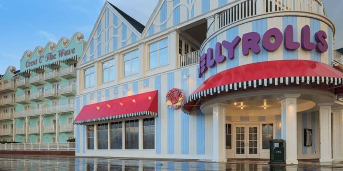 Jellyrolls dueling piano bar, with blue and white stripes and a red awning, on Disney’s BoardWalk overlooking Crescent Lake.