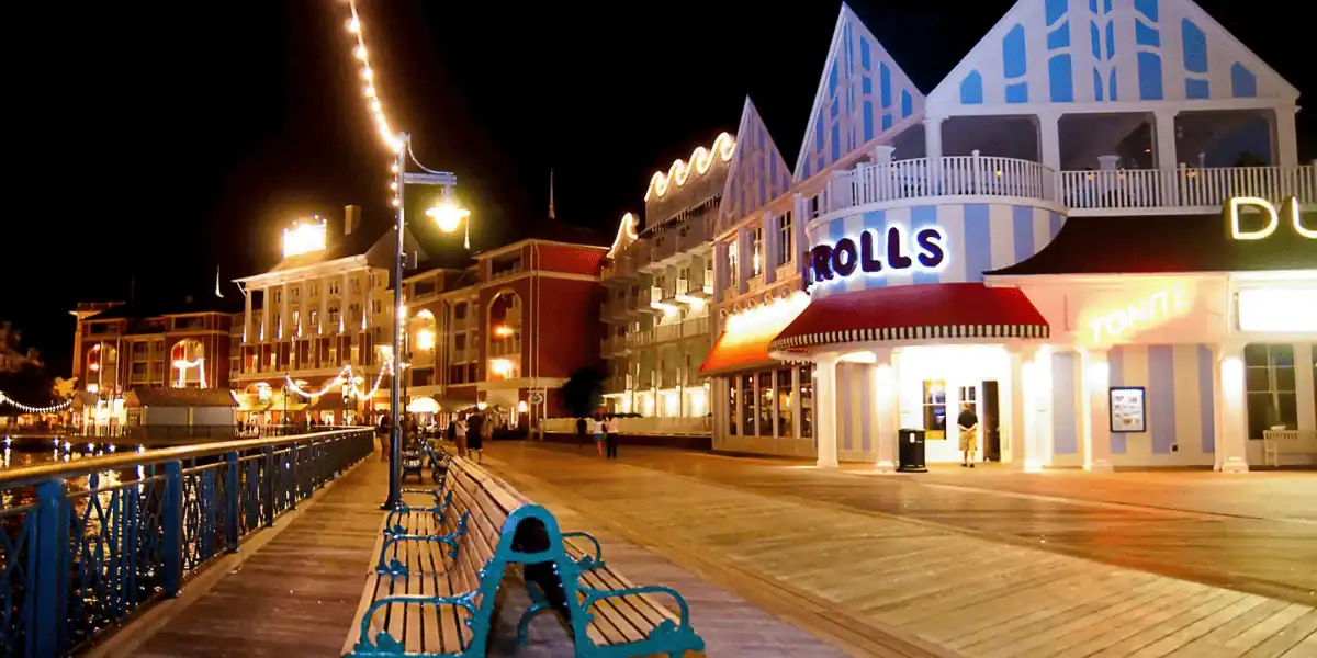 Disney’s BoardWalk glows at night, vibrant and lively by Crescent Lake, still exuding charm after recent storefront changes.