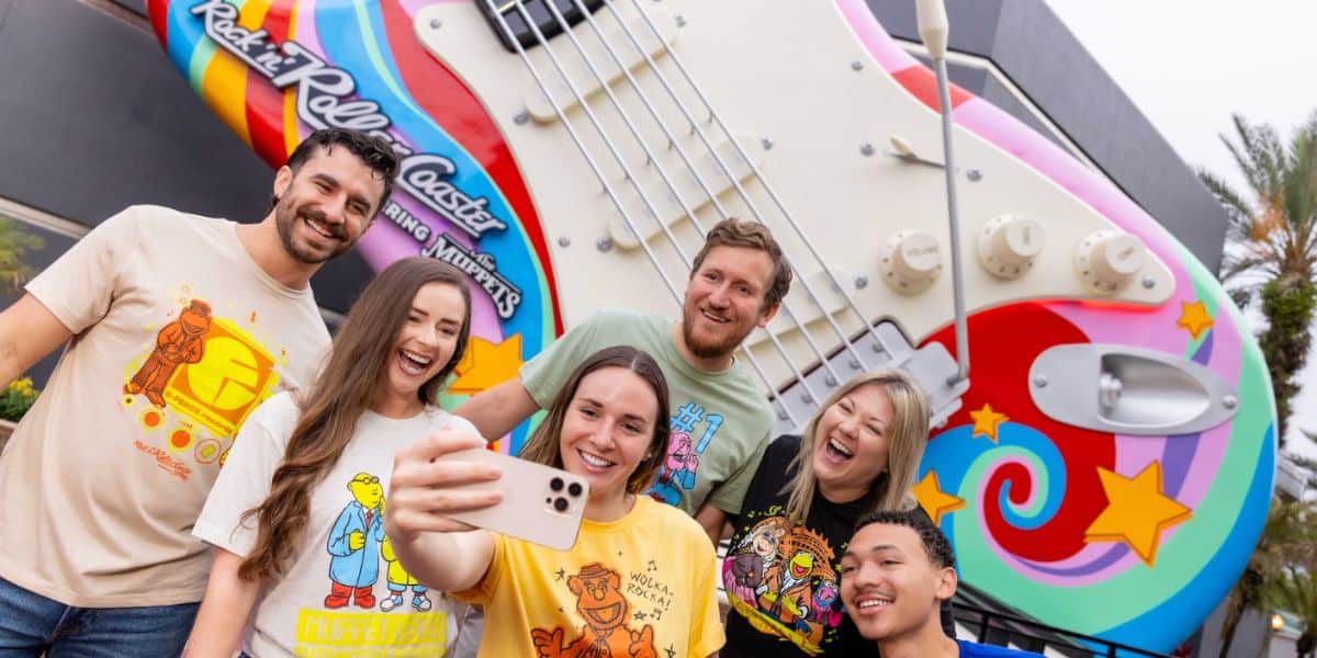 Fans pose for a selfie by the iconic Rock ‘n’ Roller Coaster guitar, pumped for Statler and Waldorf’s Muppets comeback.