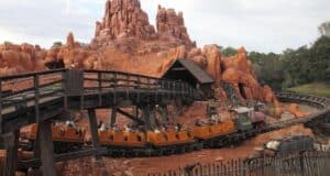 Big Thunder Mountain Railroad train races around rugged peaks at Disneyland, thrilling guests with its wild west adventure.