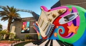 Giant, colorful guitar with stars marks the Rock 'n' Roller Coaster entrance as Statler & Waldorf return at Hollywood Studios.