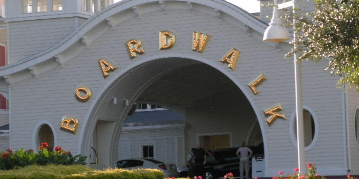 The iconic Boardwalk entrance welcomes guests with bold signage, lively crowds, and arriving cars ready for a day of fun.