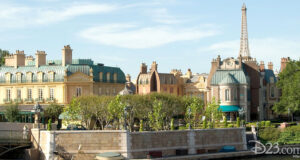 EPCOT’s France Pavilion waterfront with charming Parisian facades, lush gardens, and the Eiffel Tower replica rising behind.