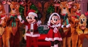 Mickey and Minnie Mouse join Pluto and reindeer in sparkling holiday attire amid festive decorations at Disney parks.