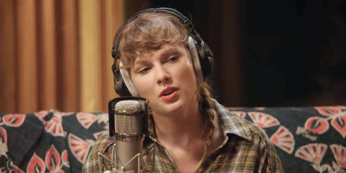 A guest on a Disney-themed sofa records vocals, headphones on, as news breaks: Taylor Swift reveals Toy Story 5 anthem.