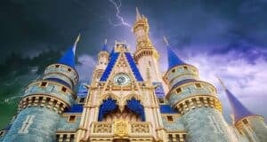 A dramatic image of Cinderella's castle at Disney World with dark, stormy skies and multiple lightning strikes illuminating the background. Disney World power outage