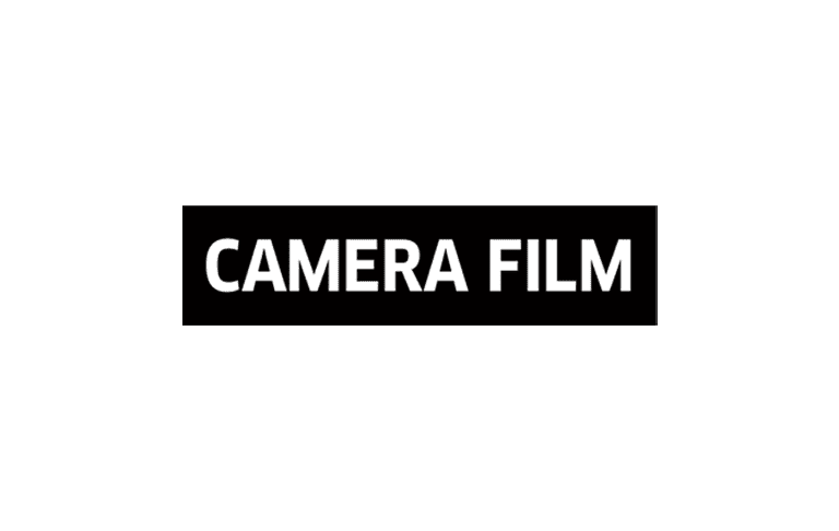 Camera film production studio workspace with professional equipment and editing screens.