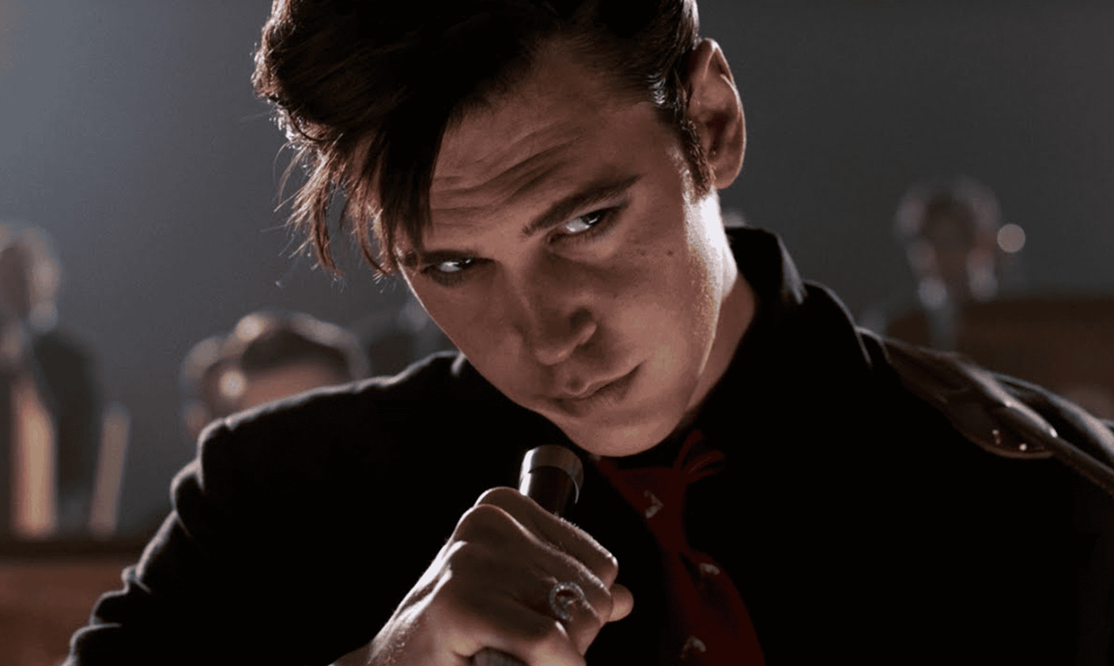 Cinematic close-up of a young man with intense expression holding a microphone, showcasing professional post-production film editing, color grading, and visual effects by DIVO Post Production.