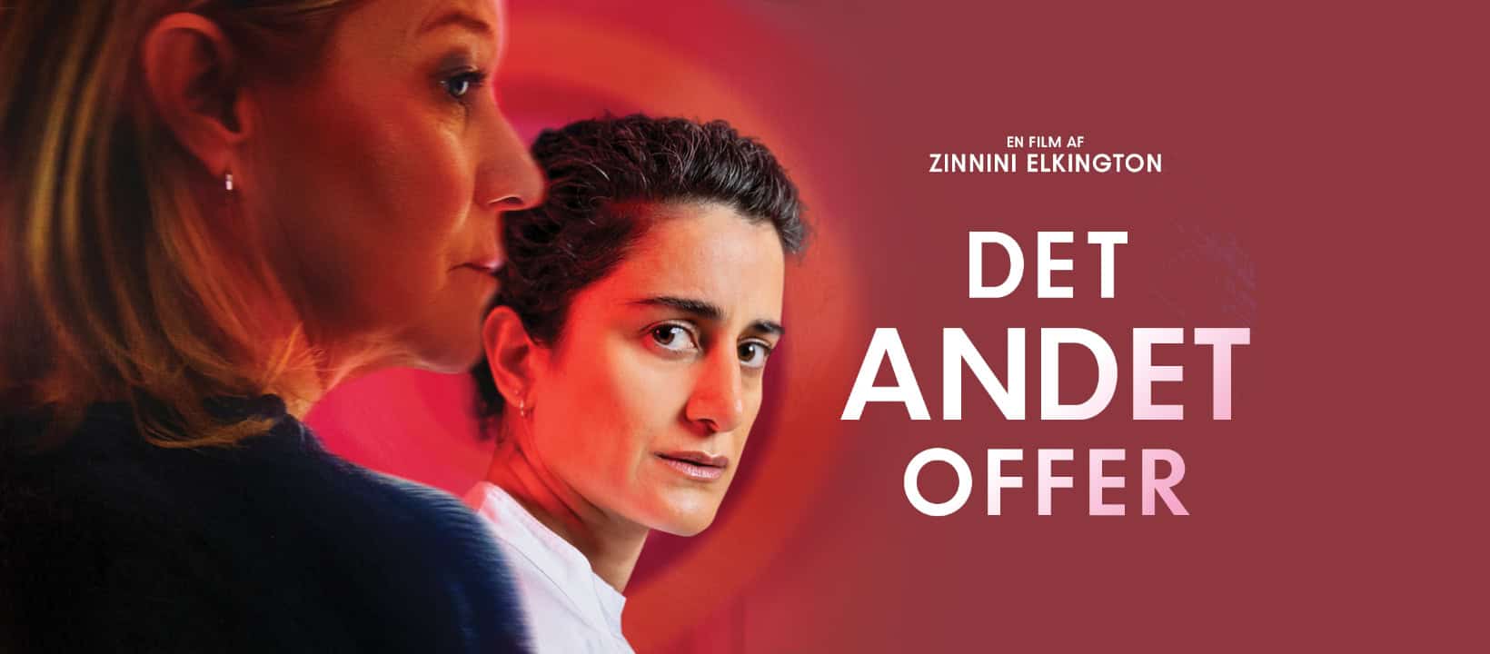 Grainy close-up of two women, portrait shot, with one woman in the background looking serious.