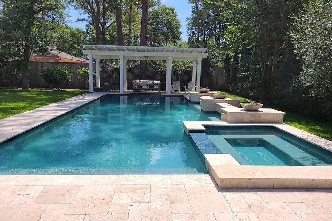 Beautiful backyard swimming pool with modern features in West University Place, Texas. Perfect for outdoor relaxation and entertainment, showcasing custom pool construction by Downunda Pools.