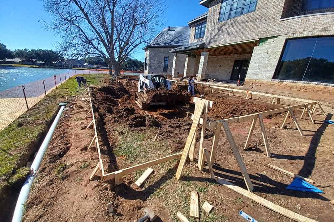 Excavation work for pool installation at a luxury suburban home by Downunda Pools. Skilled team preparing the backyard for a custom in-ground swimming pool construction.