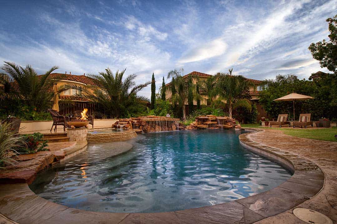 River Oaks custom backyard swimming pool with rock waterfall