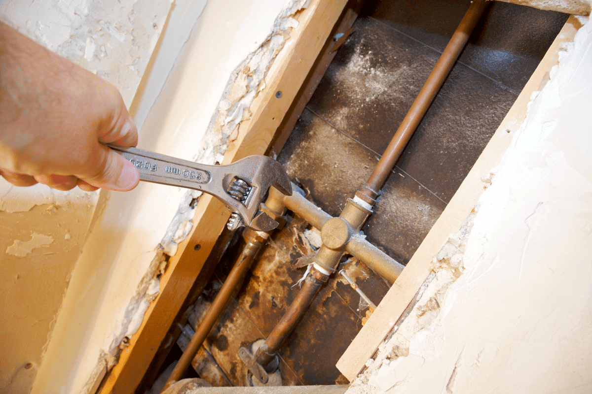 Technician repairing a shower drain for optimal water drainage.