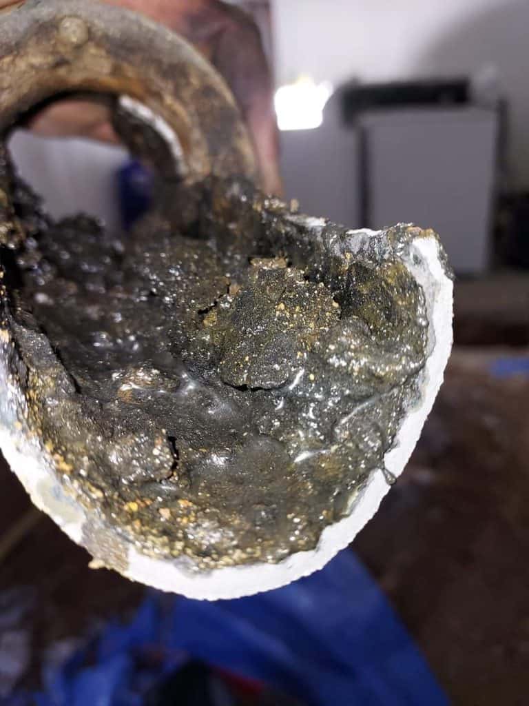Technician inspecting a clogged drain