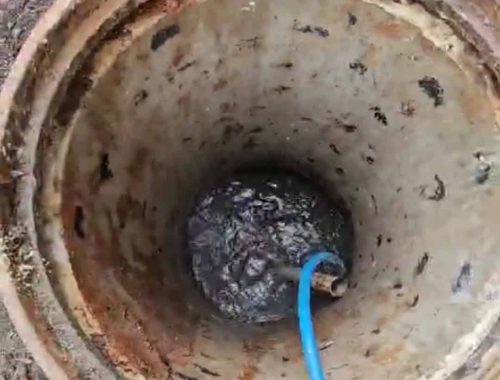 Drain Jetters R Us team inspecting a drain blockage with specialized equipment."