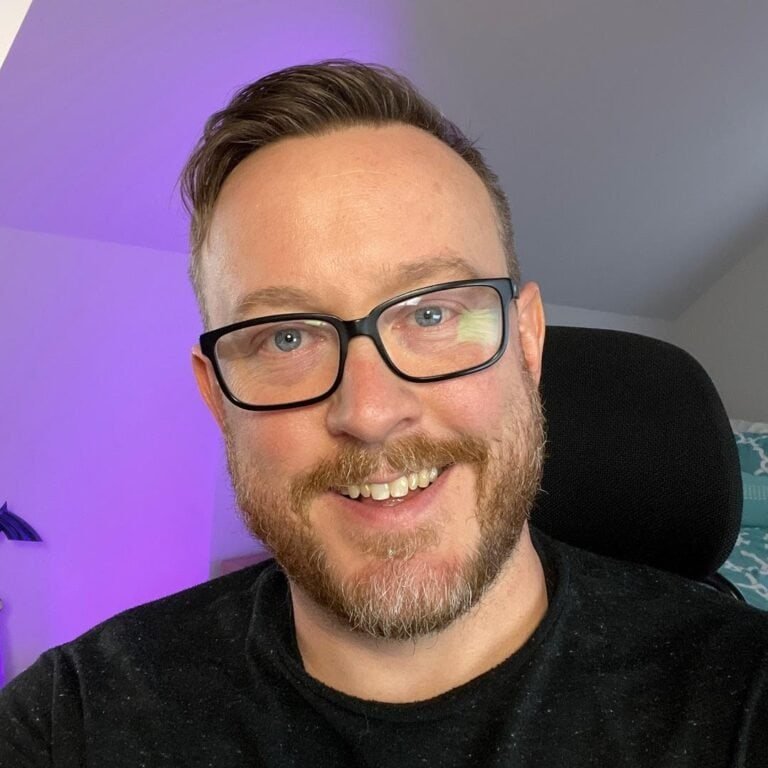 Drew from Dry Herb Vape Zone, seated in purple lighting, cannabis tech reviewer