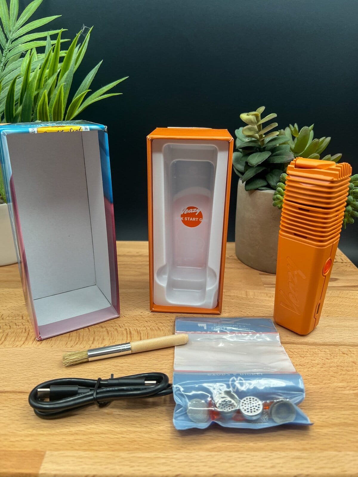 Unboxing the Storz & Bickel Veazy vaporizer in orange with included accessories — featured in our Veazy Review.