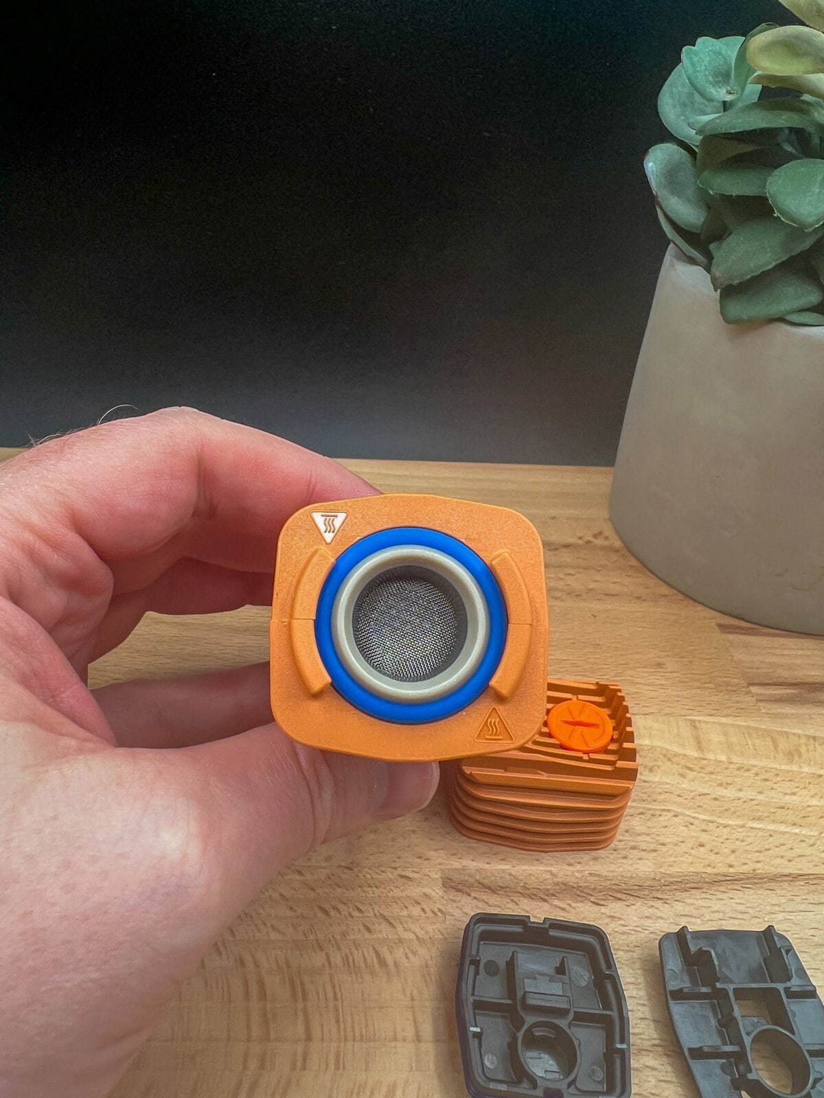 Close‑up of the Storz & Bickel Veazy vaporizer cooling unit and screen components in hand — featured in our Veazy Review.