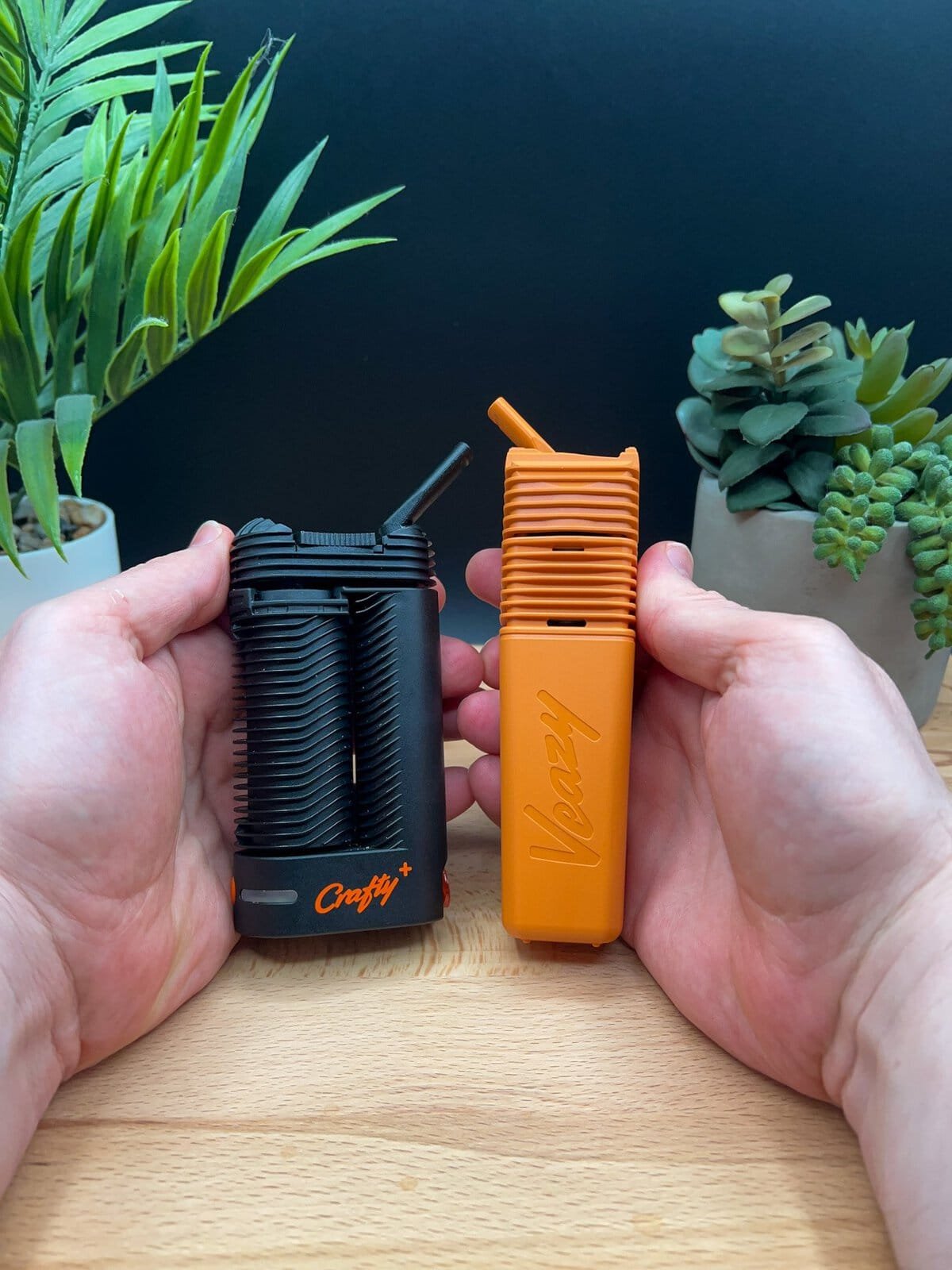Handheld comparison of the orange Storz & Bickel Veazy and a Crafty+ vaporizer — featured in our Veazy Review.