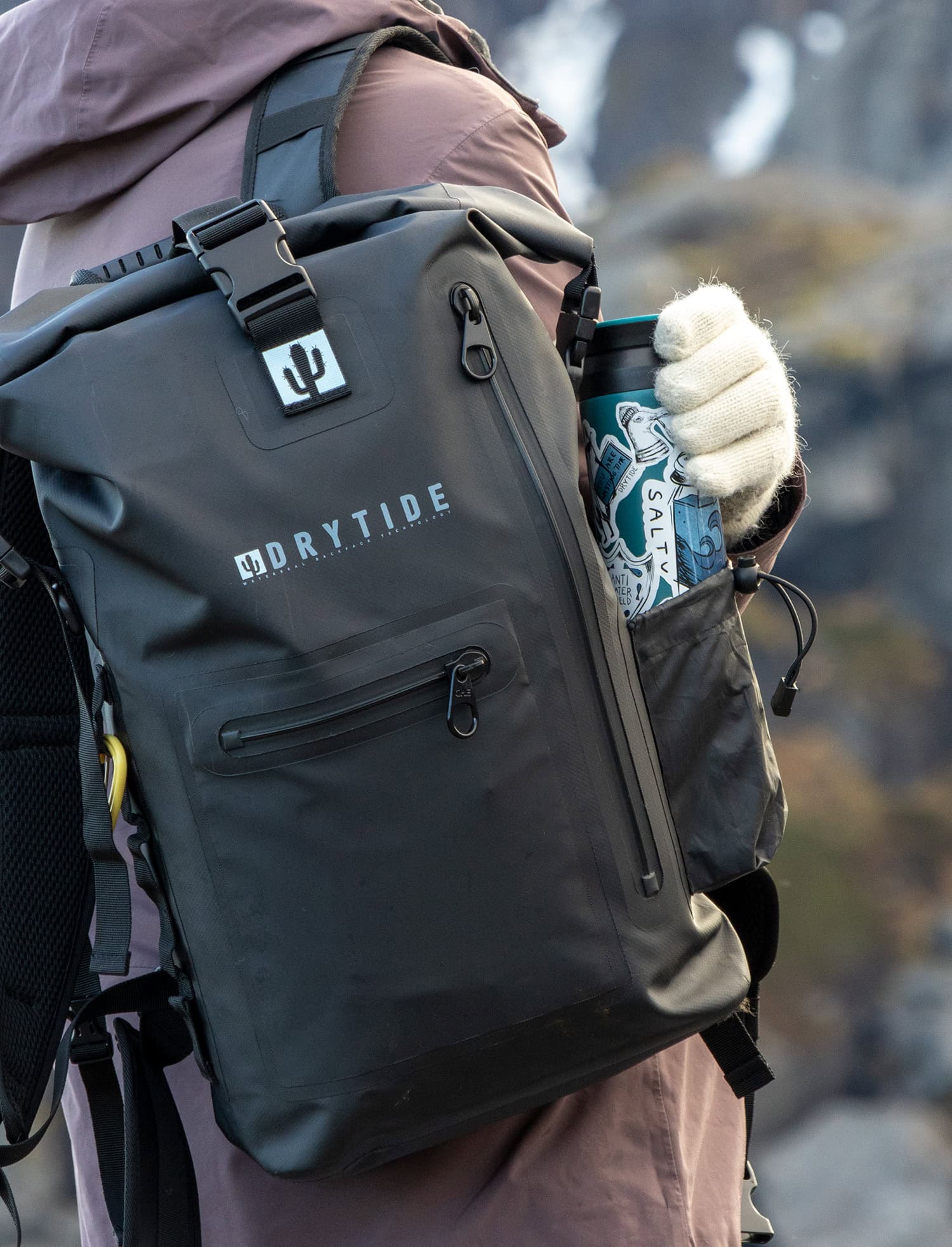 Waterproof backpack with front pocket and side bottle holder, ideal for outdoor adventures.