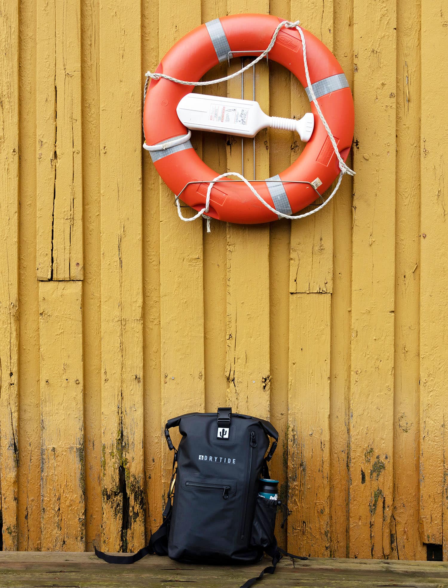 Waterproof backpack with life buoy and safety light for outdoor adventures.