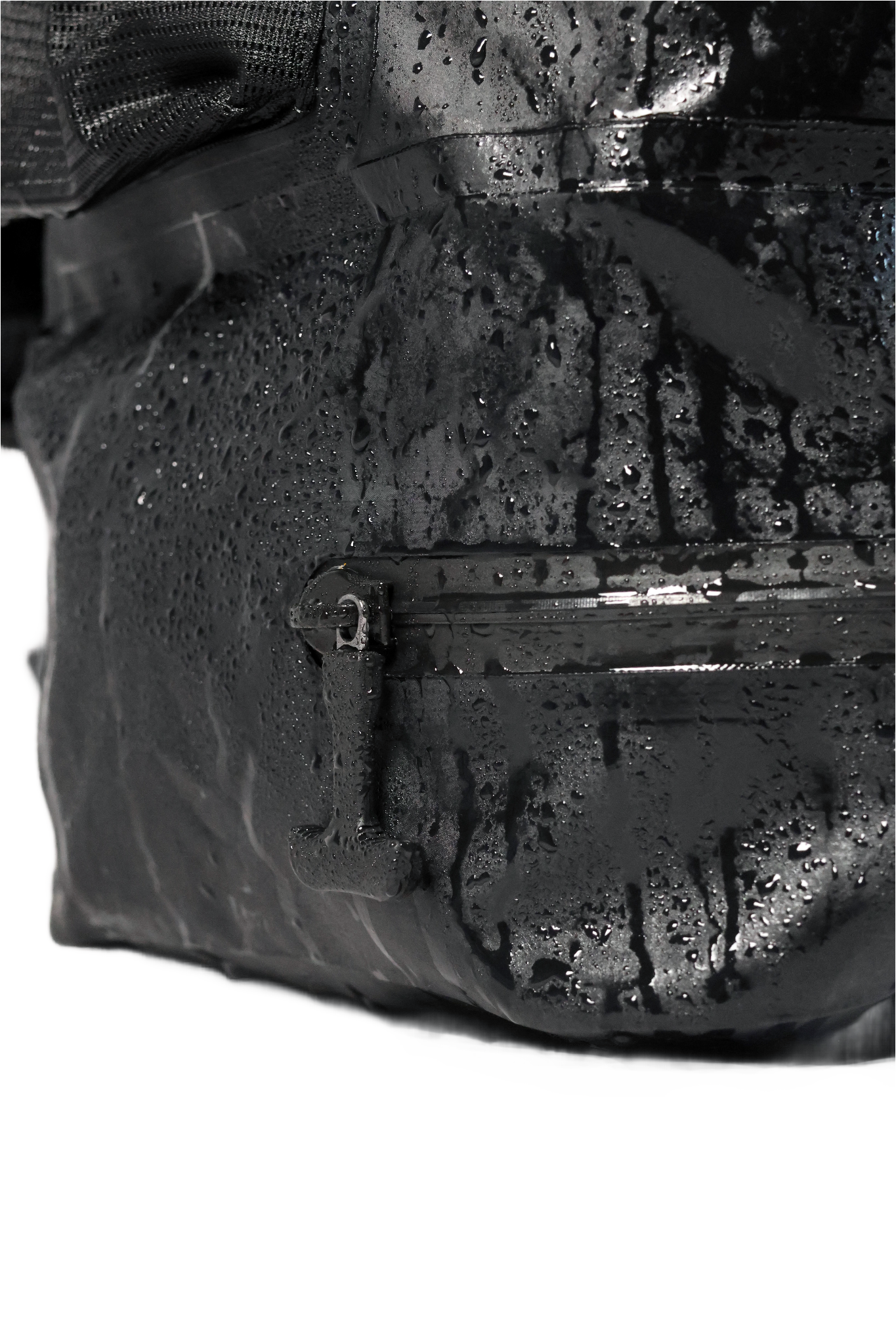 Close-up of a waterproof backpack with water droplets on its surface.