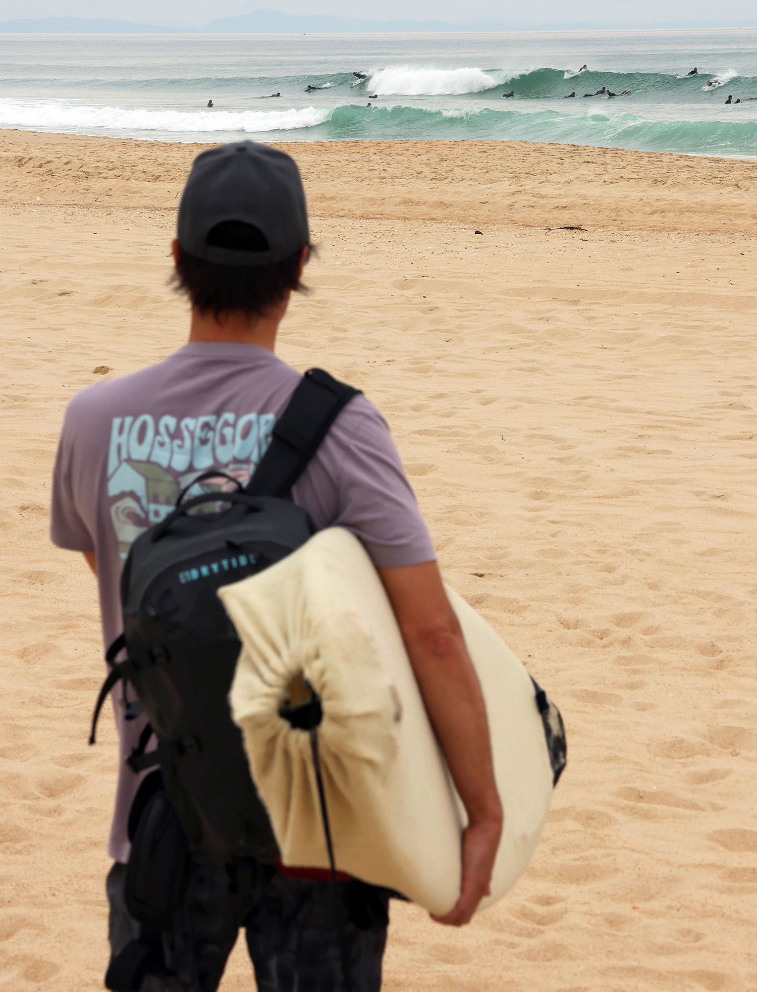 Waterproof backpack for surfing and beach adventures, durable and dry for outdoor water activities.