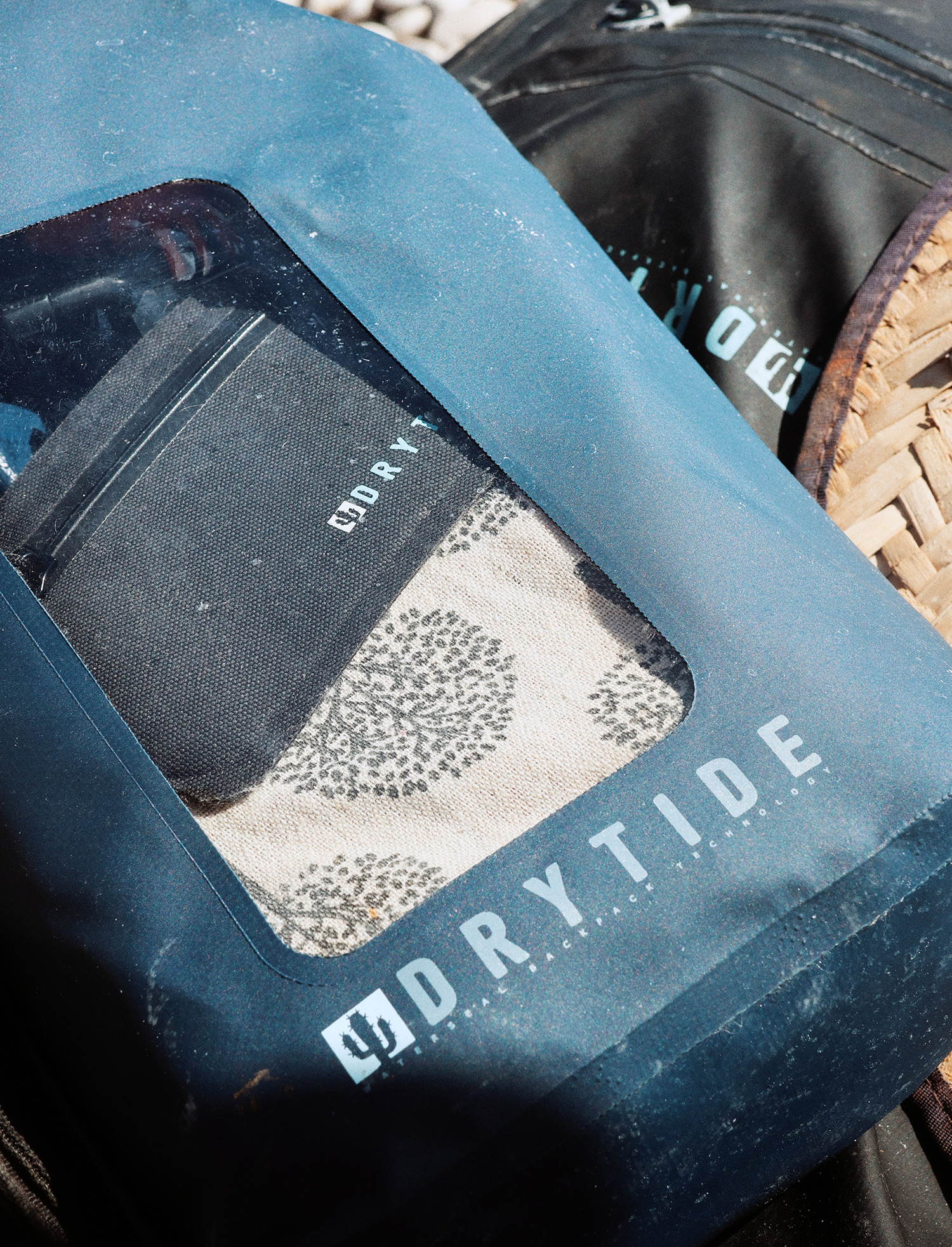 Waterproof backpack with clear window and DRYTIDE logo, designed for outdoor gear protection.