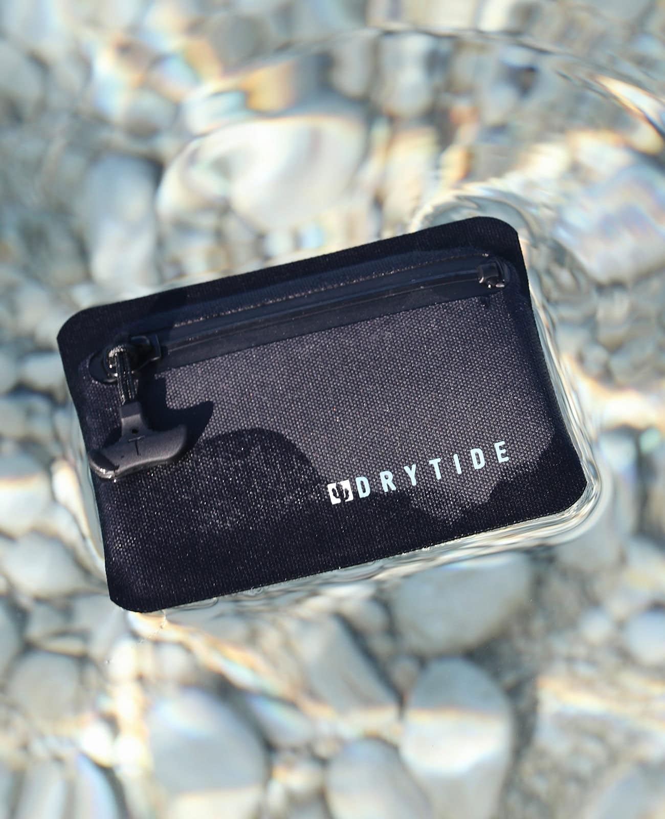 DryTide waterproof wallet floating in the water.