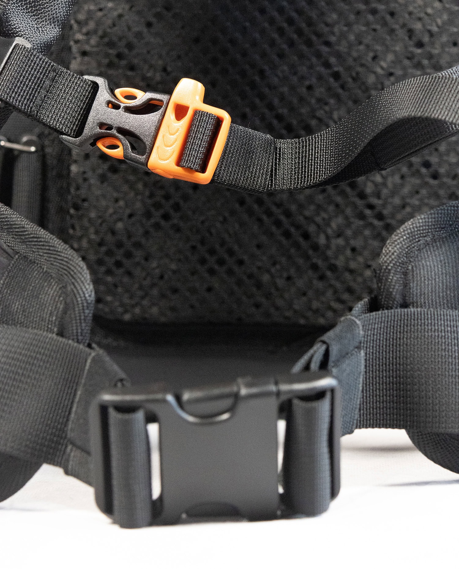 Close-up of waterproof backpack strap with secure buckle and adjustable features.