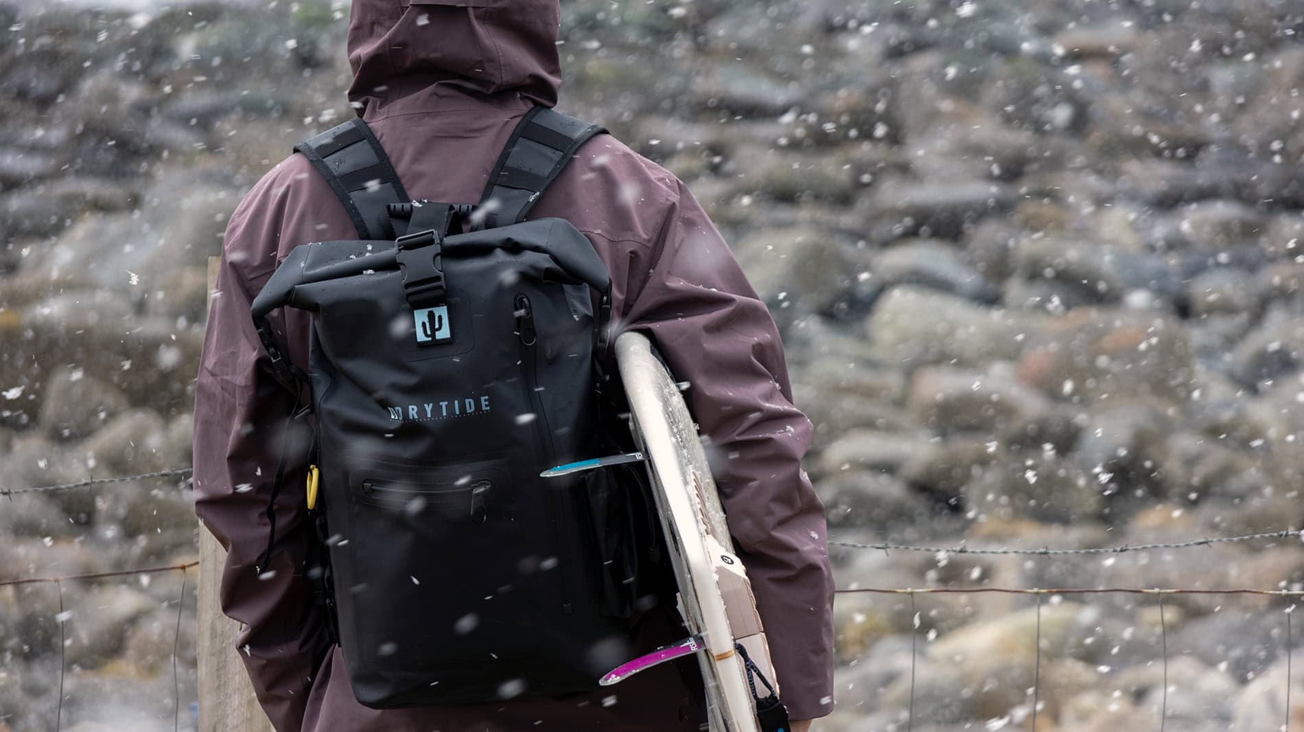 Surfer with DryTide waterproof backpack at Unstad, Lofoten islands.
