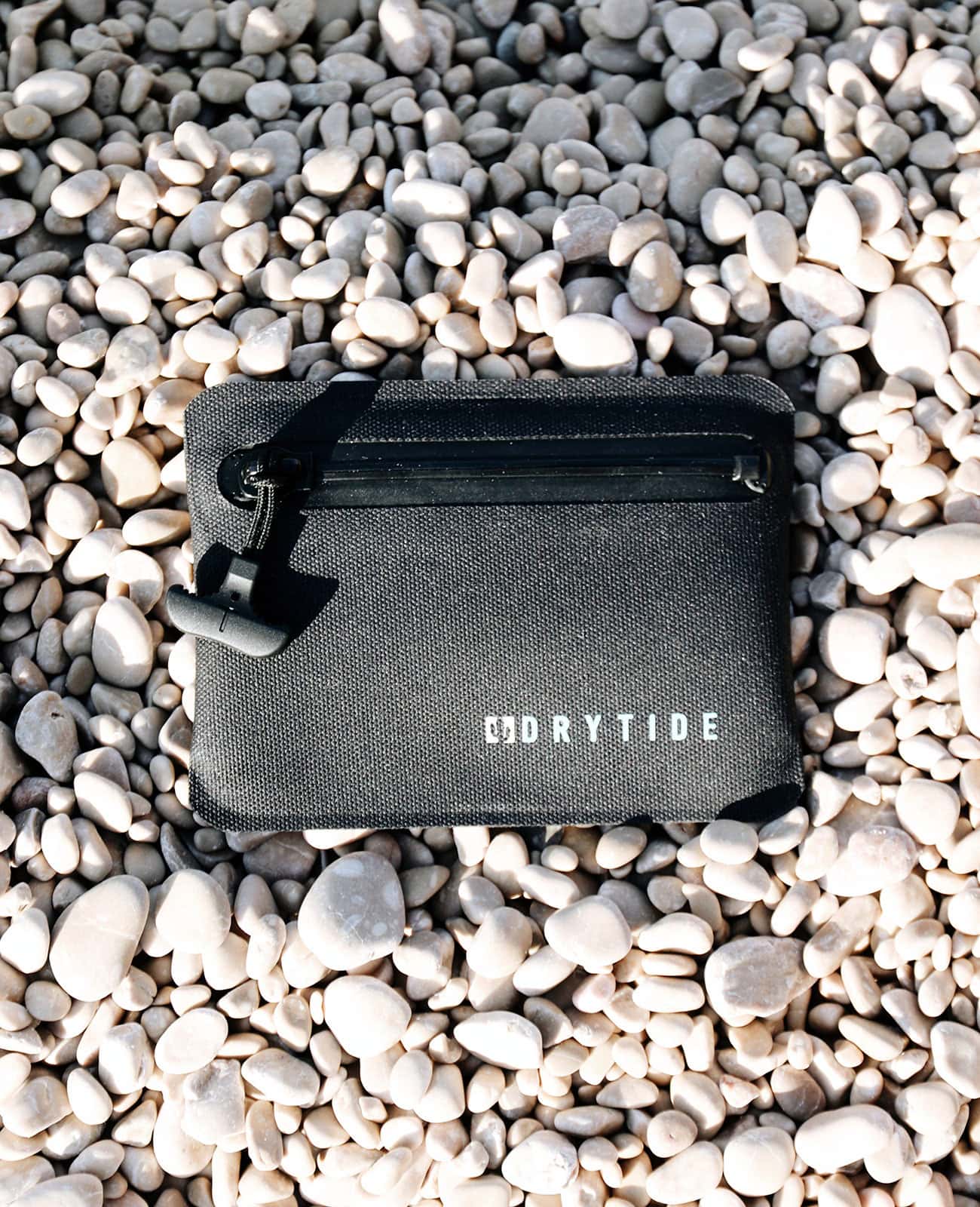 Waterproof wallet laying on the beach.