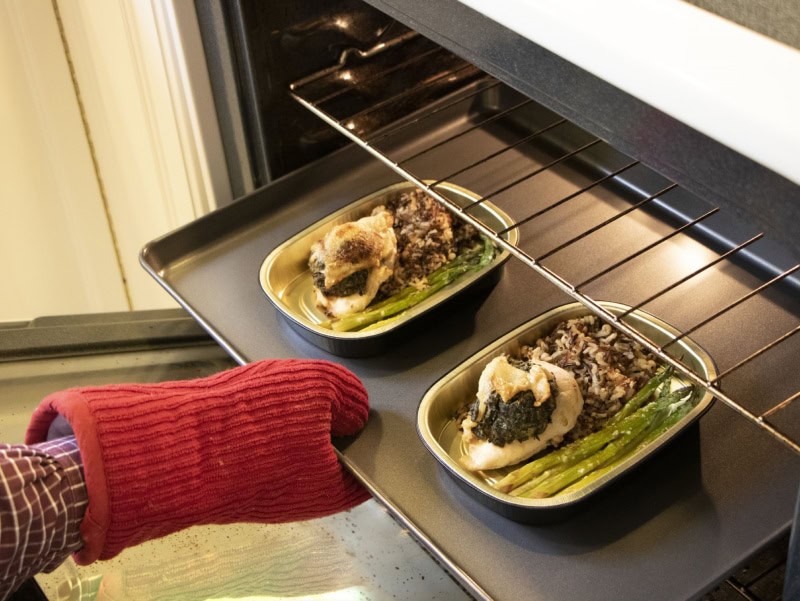 gourmet meals being taken out of the oven