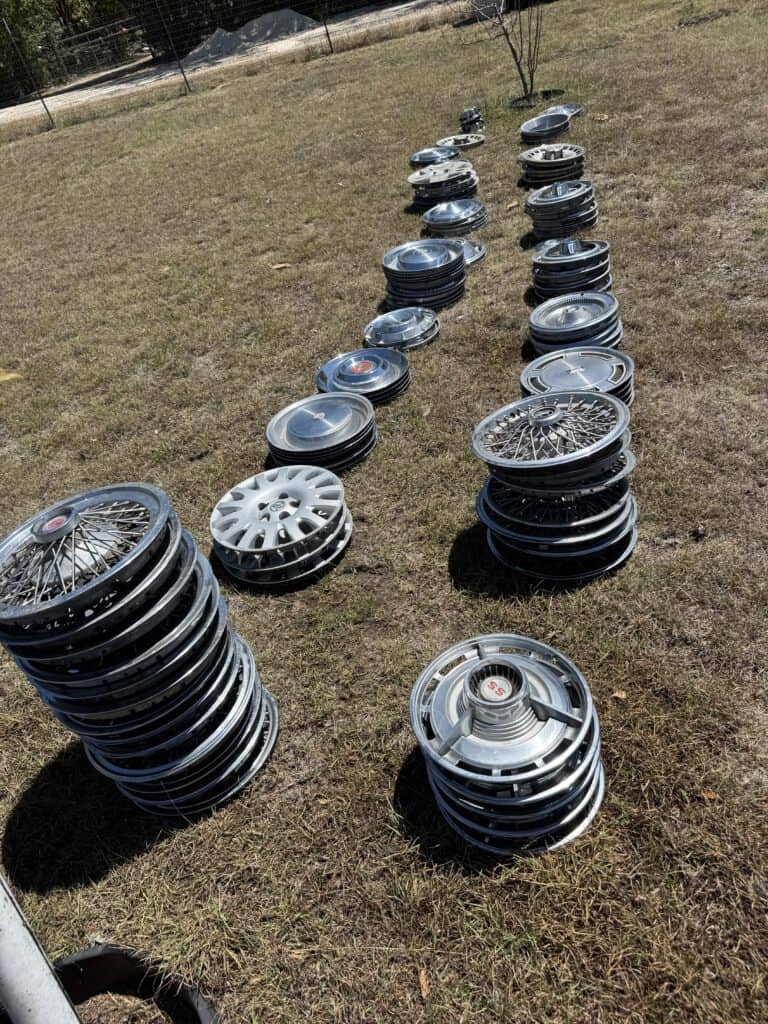 Wheel rims and tires displayed outdoors at Garrett Realty & Auction.