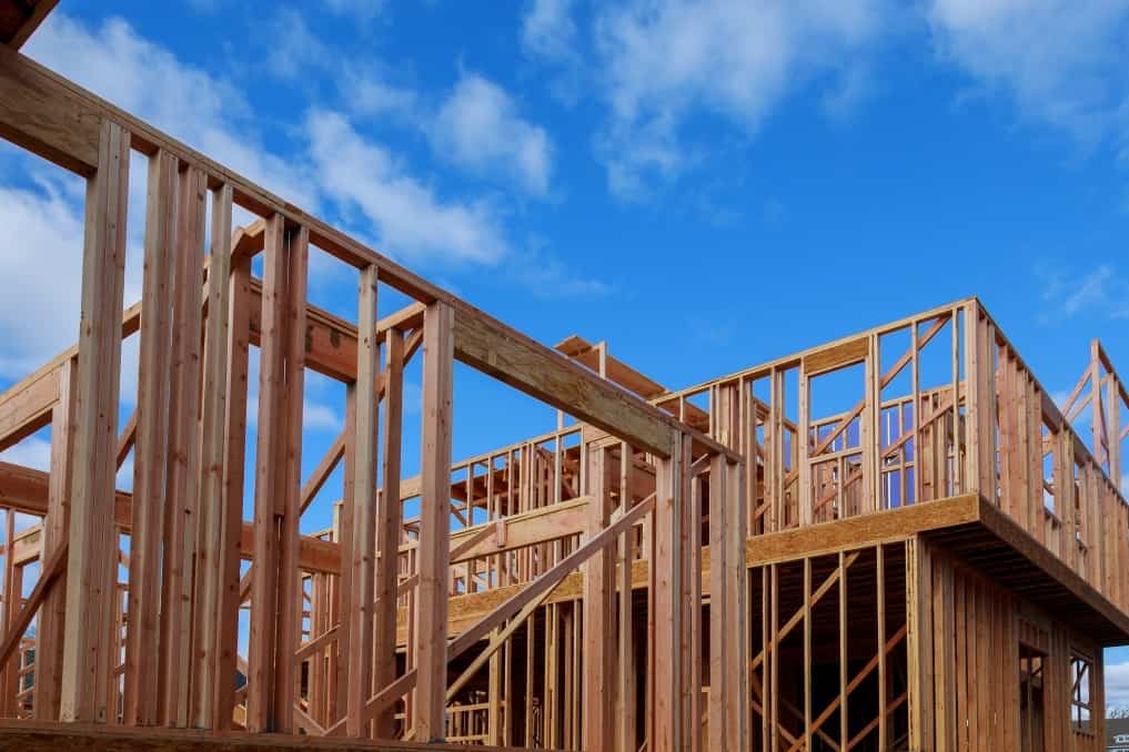 wood frame of a home with the blue sky in the background