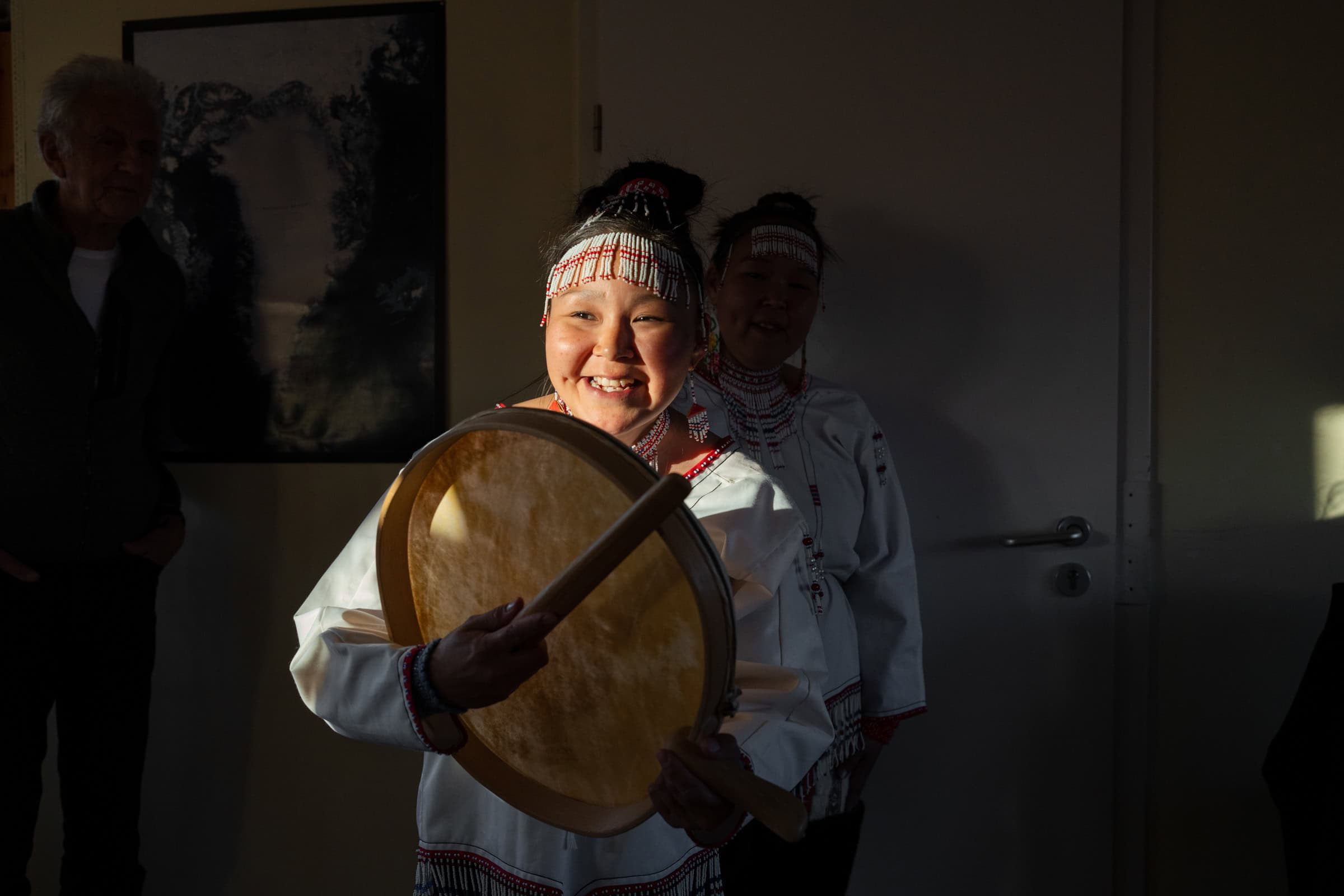 Portrait shot of drum dancer in Tasiilaq in evening sunlight. Photo by Filip Gielda - Visit East Greenland