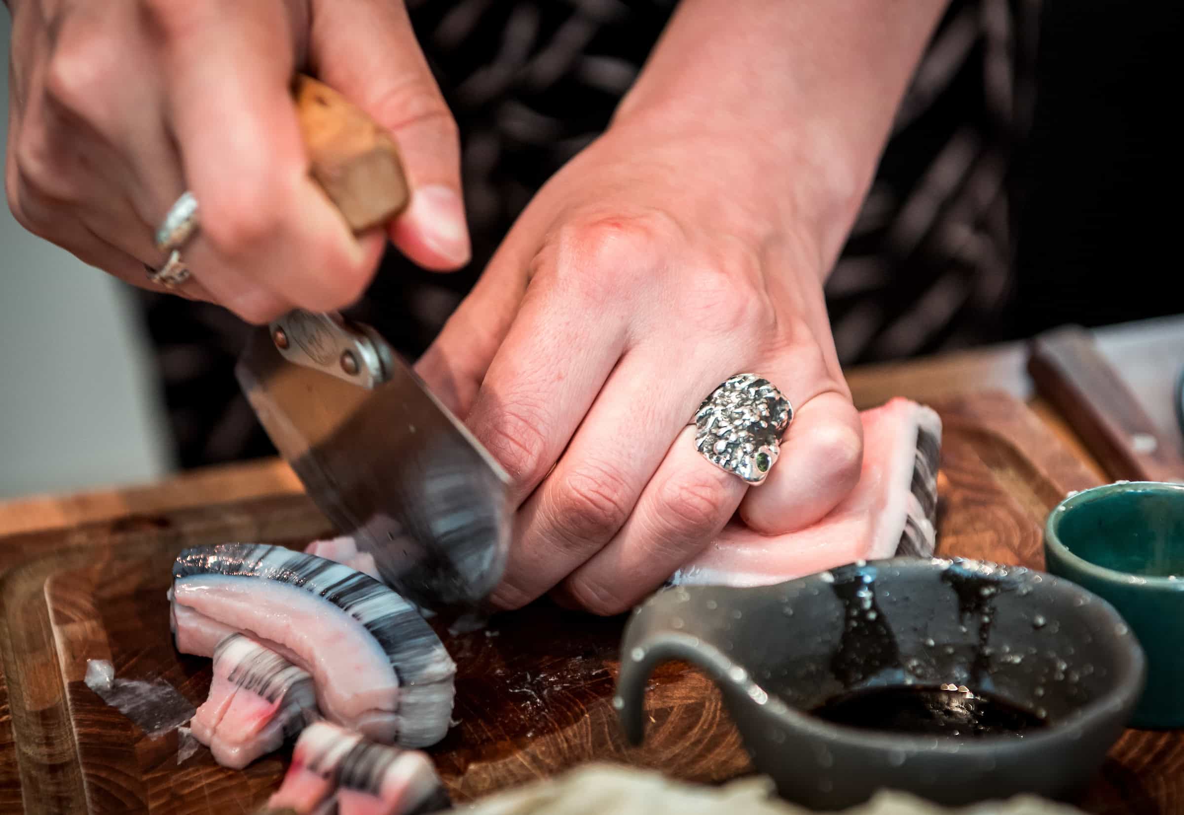 Cutting Mattak With an Ulu. Photo by Lola A. Åkerström - Visit Greenland