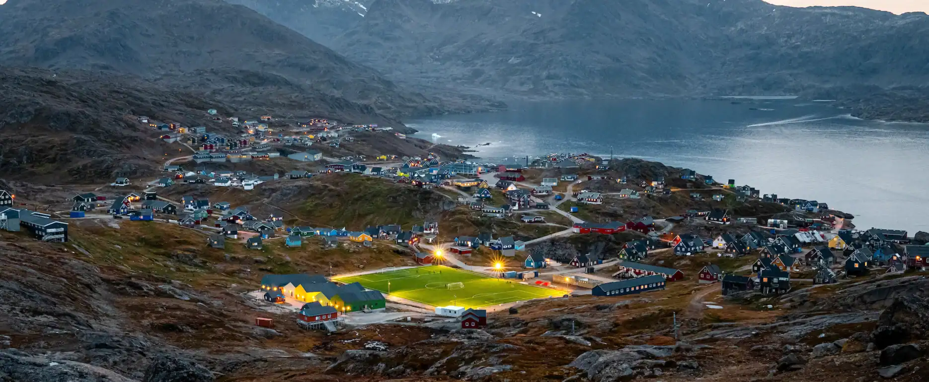 Tasiilaq and the football field. Photo by Chris König - Visit Greenland