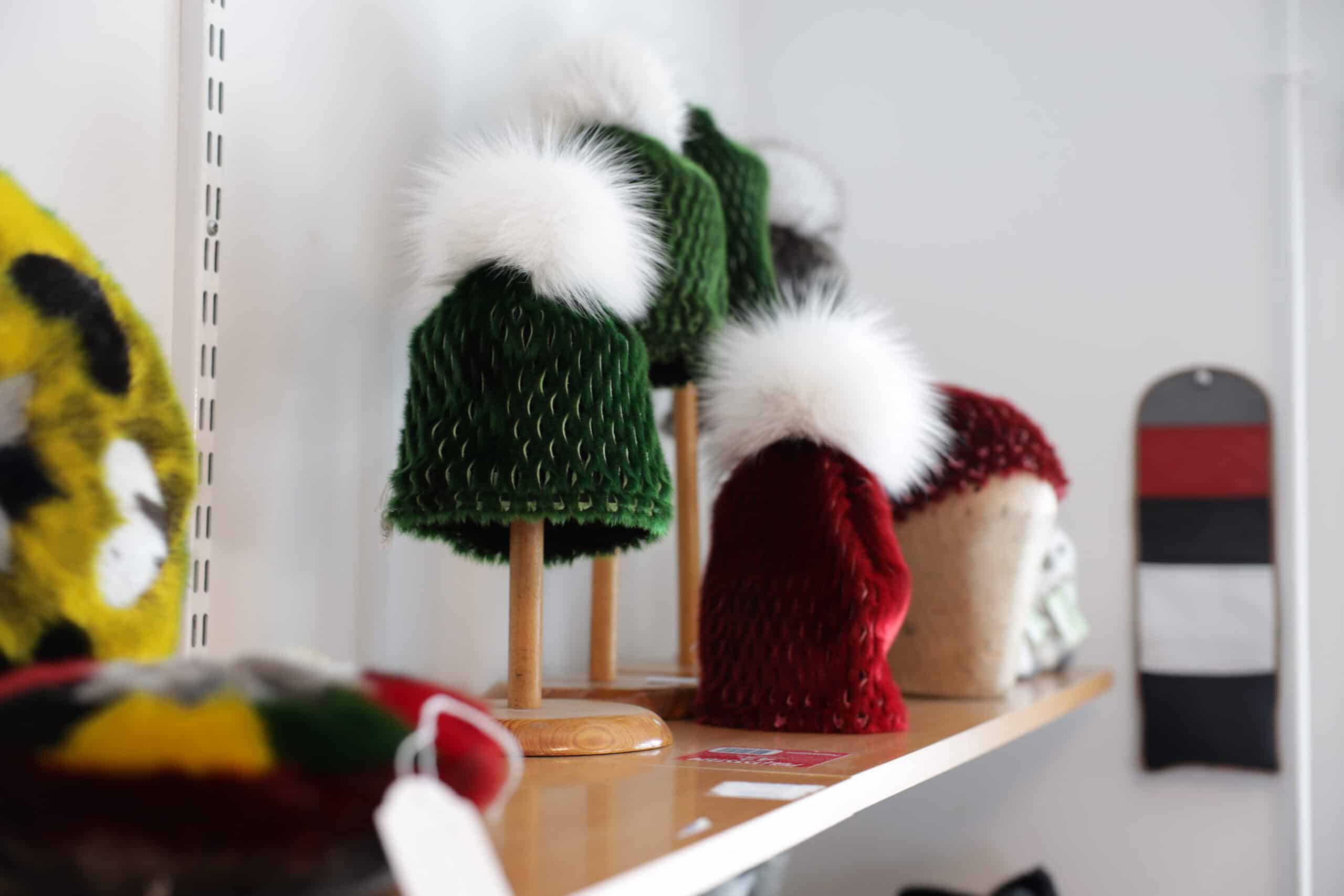 Variety of colorful hats made out of sealskin.