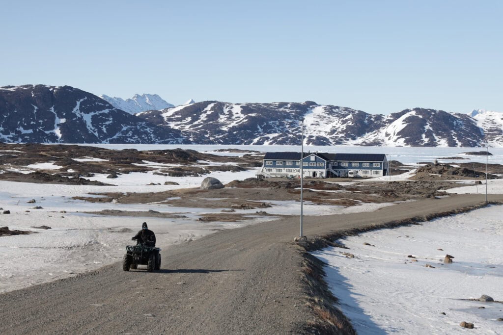 ATV riding on the paved road between Kulusuk Airport and Kulusuk Hotel.