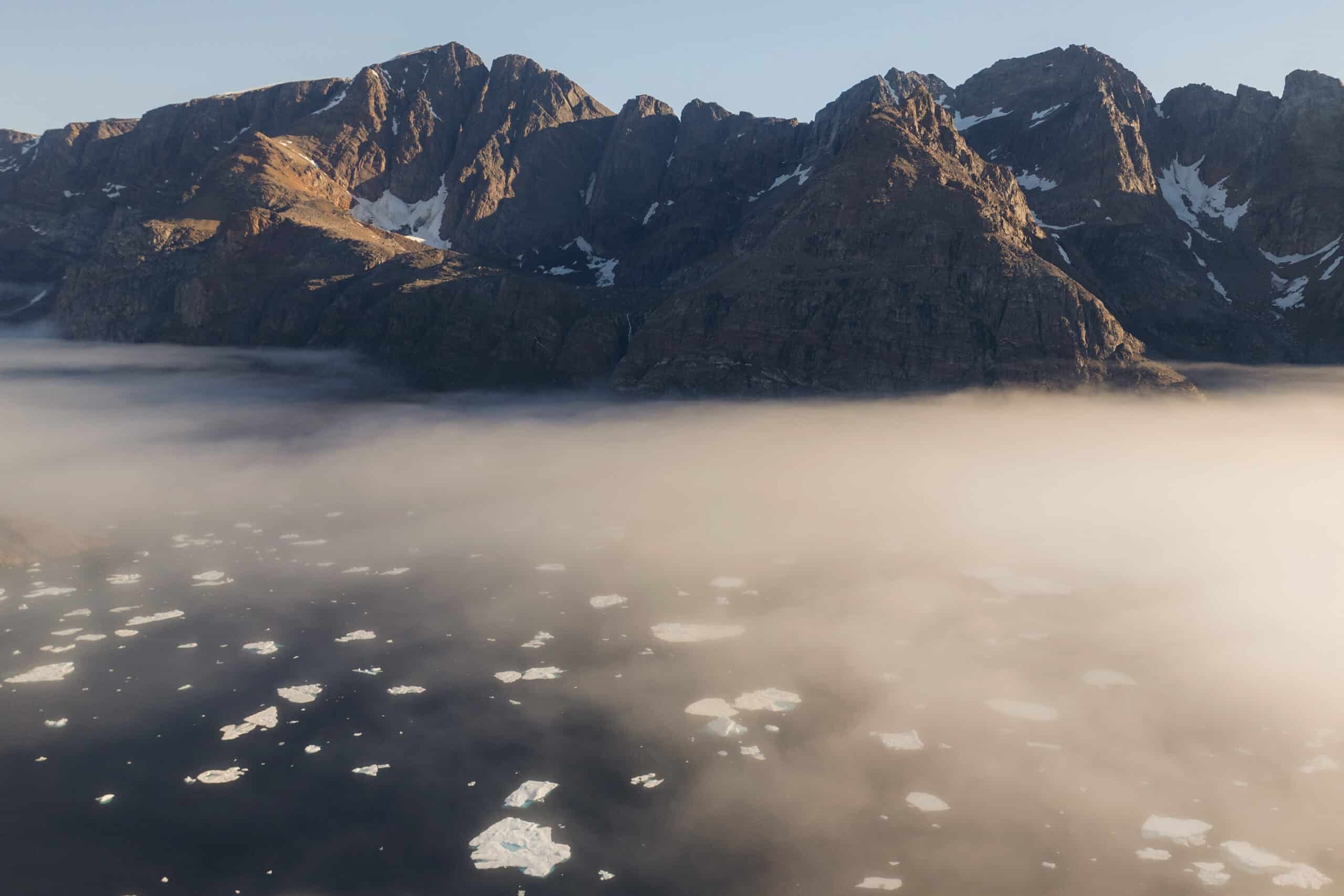 Foggy Sunrise with icebergs beneath.