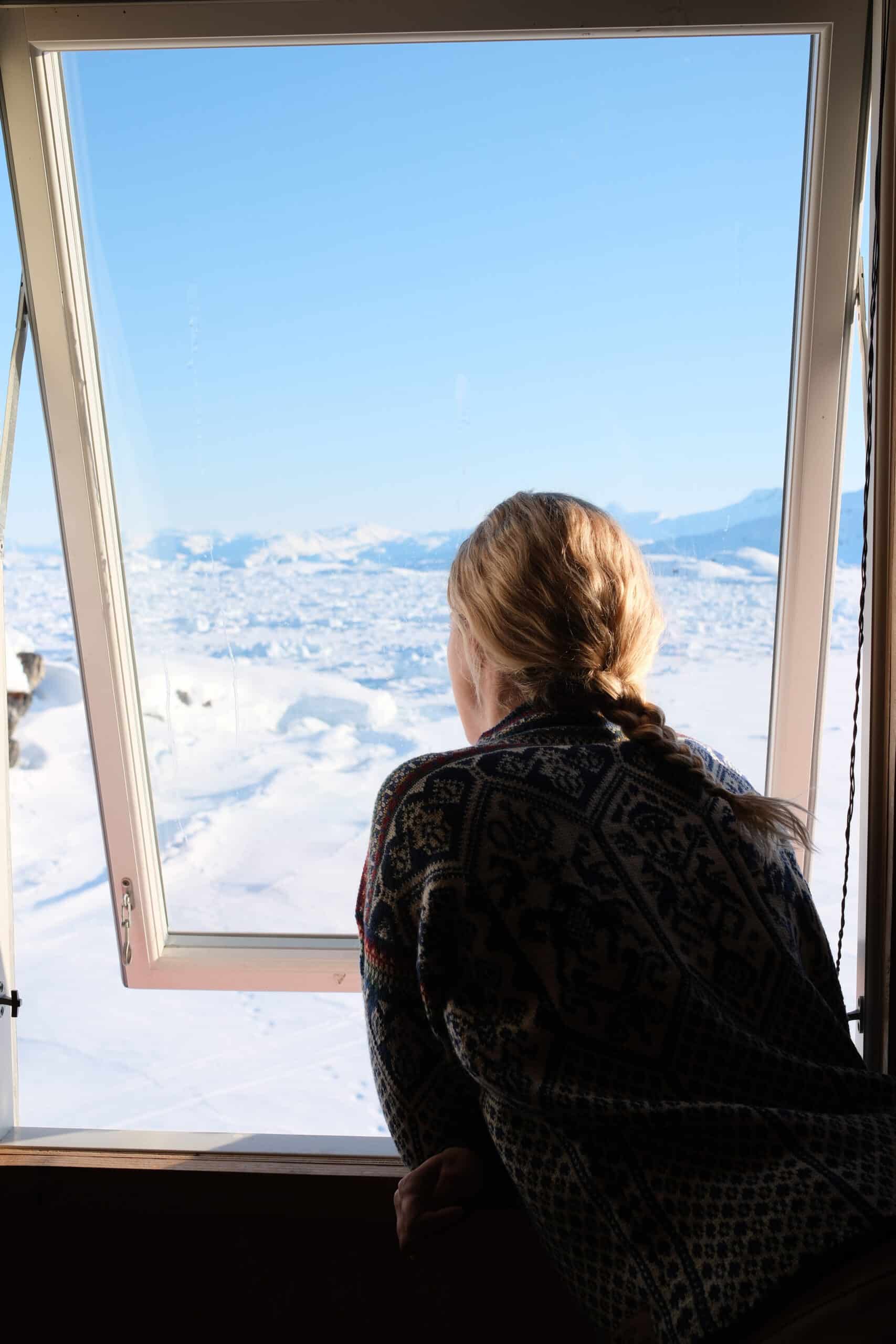 Looking out the window onto the frozen fjord of Sermilik Fjord after fresh polar bear tracks.