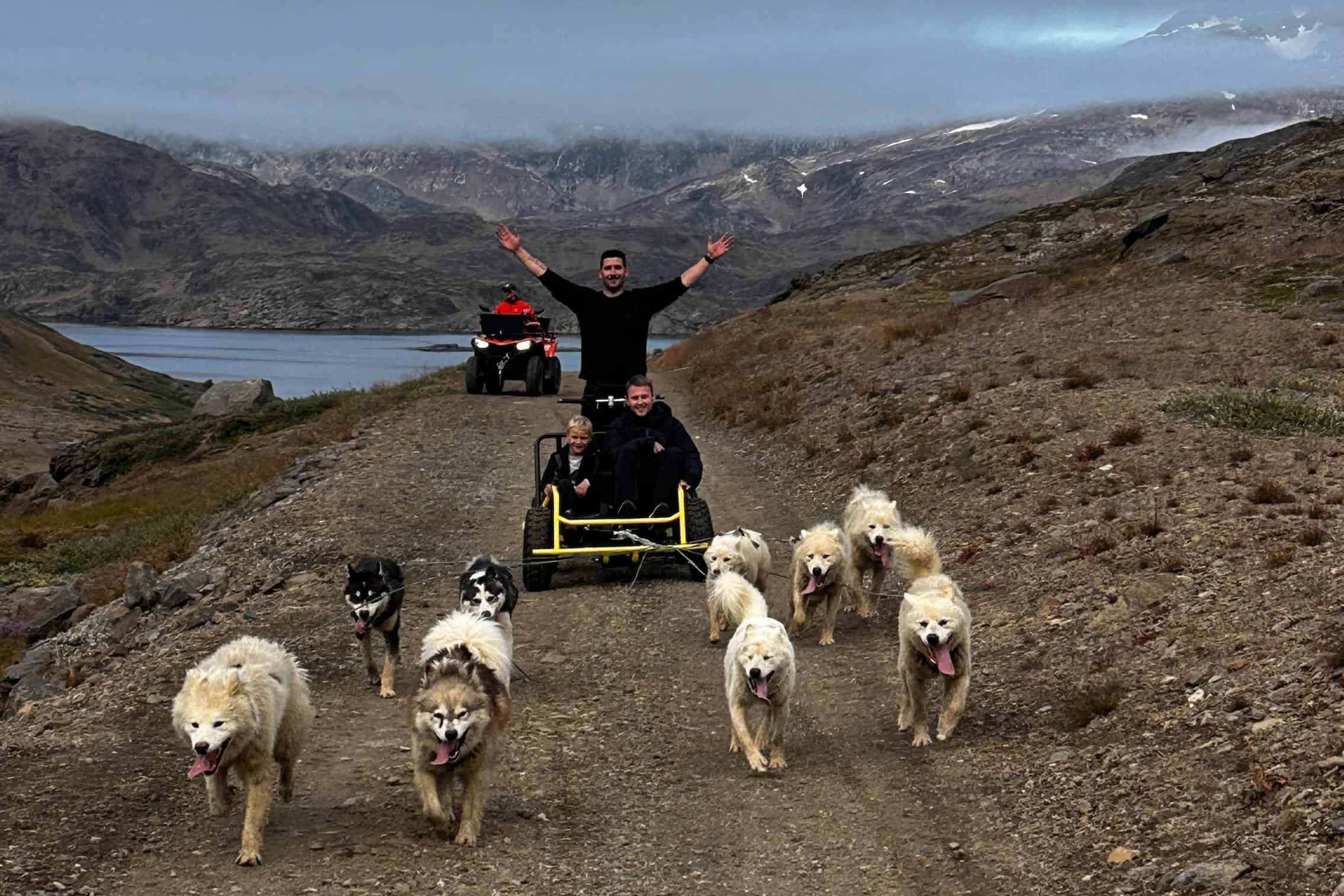 Tourist enjoying a summer dog sledding experience on wheels.