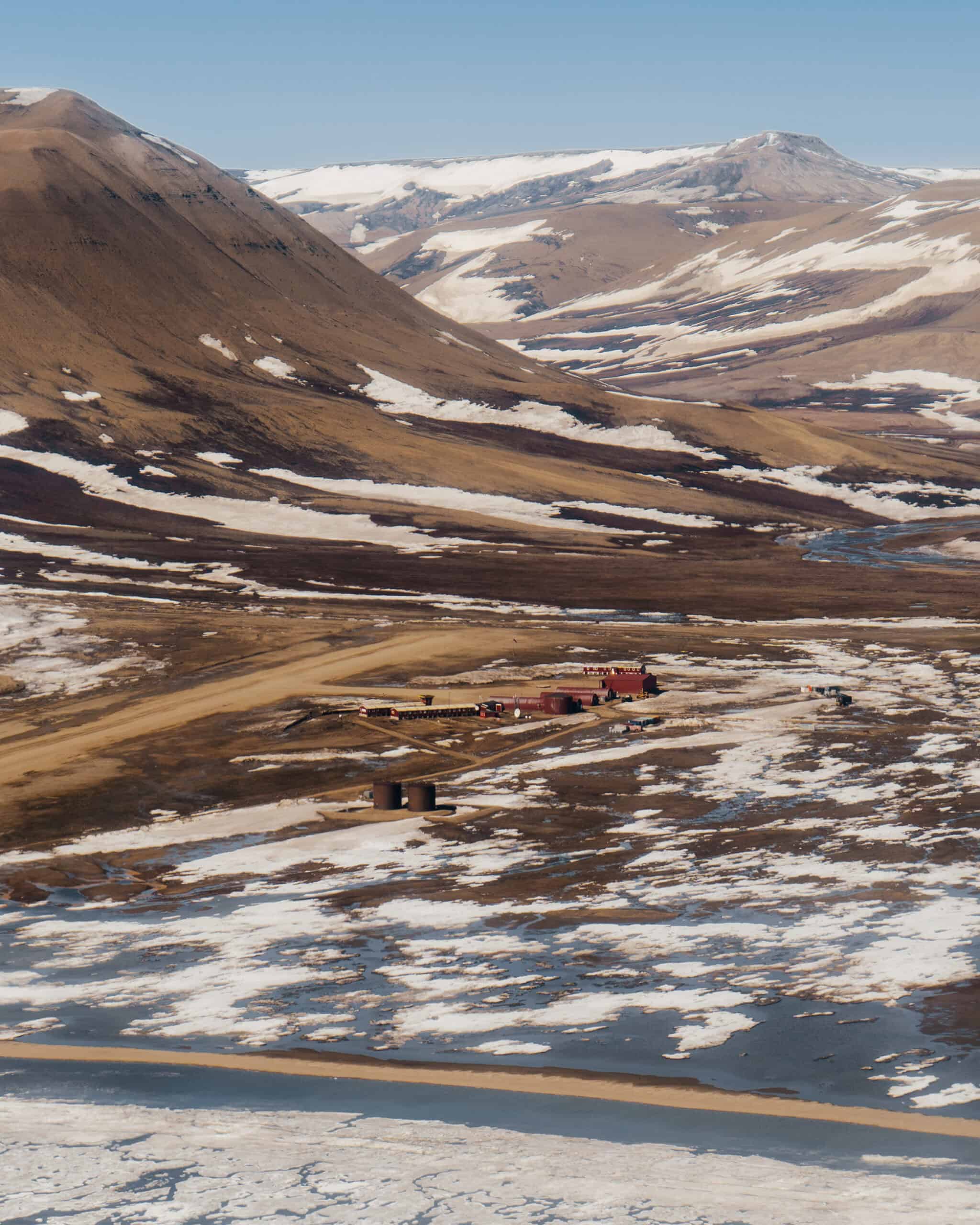 Nerlerit Inaat's entire footprint fits into a handful of buildings: red steel Quonset huts, a raised control tower, two fuel tanks, and a gravel apron.
