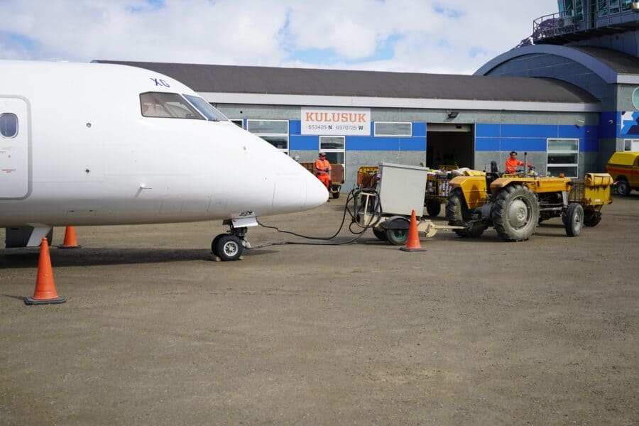 Aircraft parked at Kulusuk Airport fueling up before take-off.