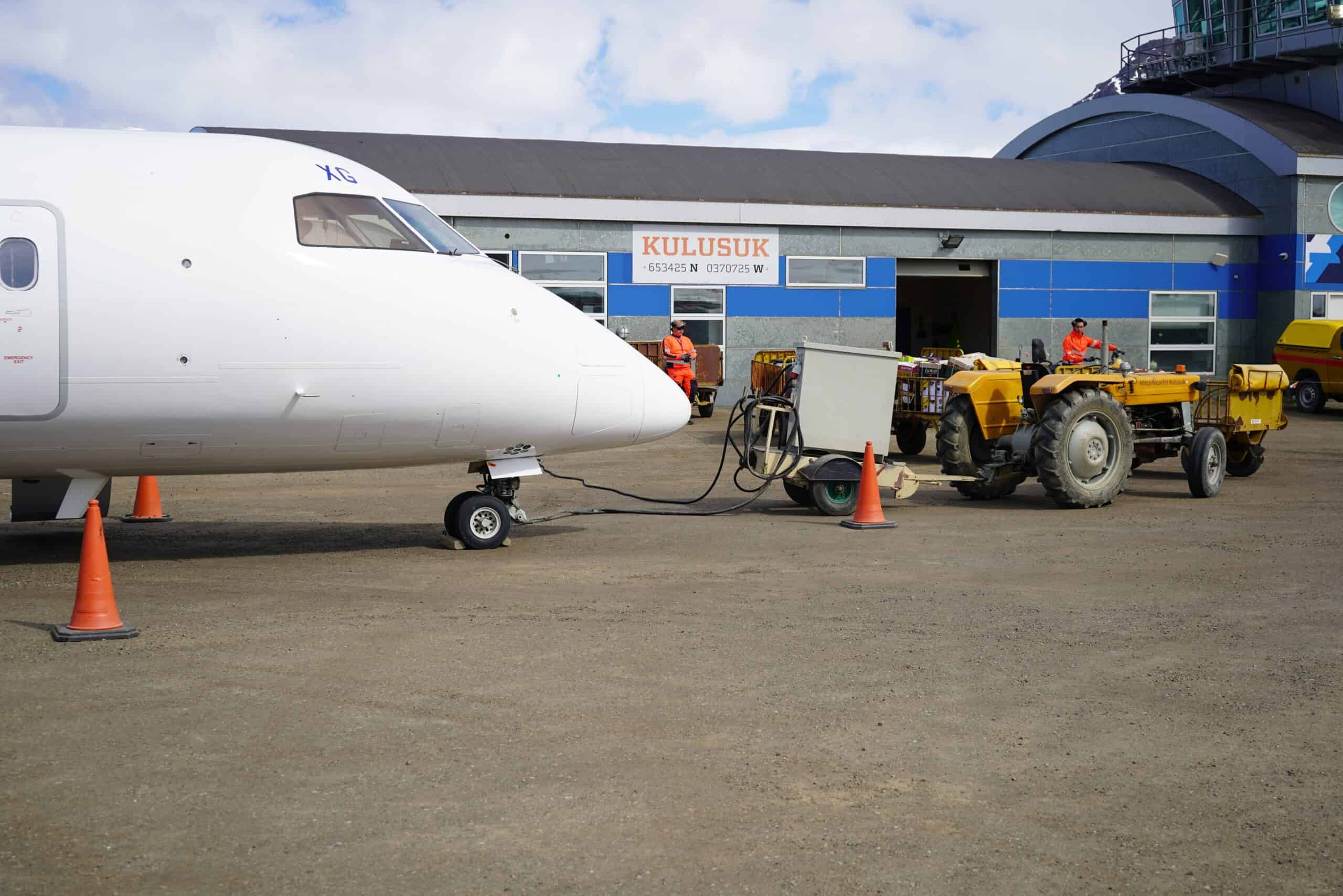 Aircraft parked at Kulusuk Airport fueling up before take-off.