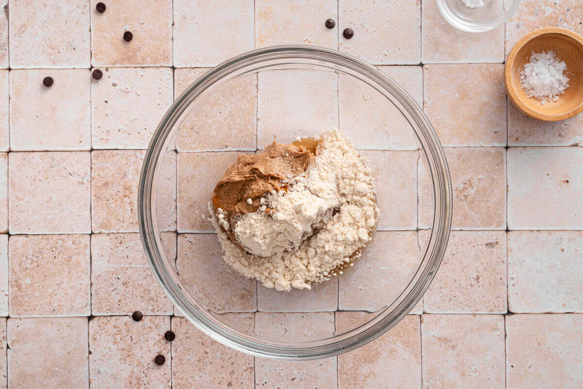 this shows me adding the peanut butter, maple syrup and almond flour in a bowl
