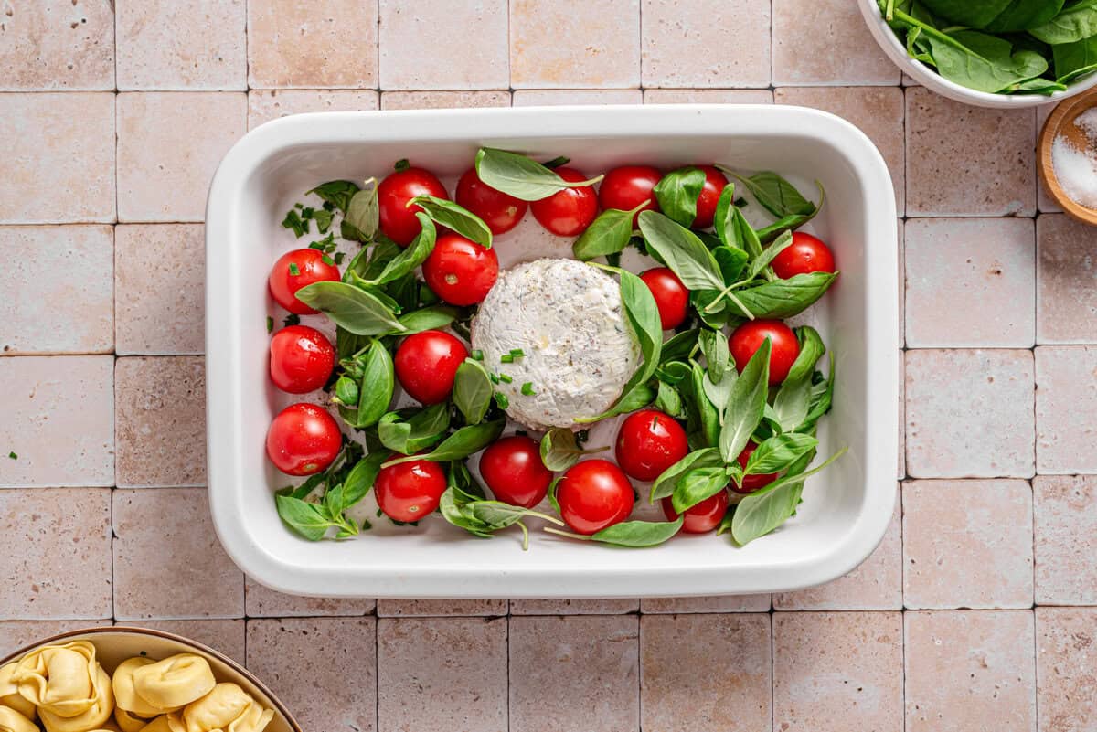 this shows me adding the basil and herbs to the pan 